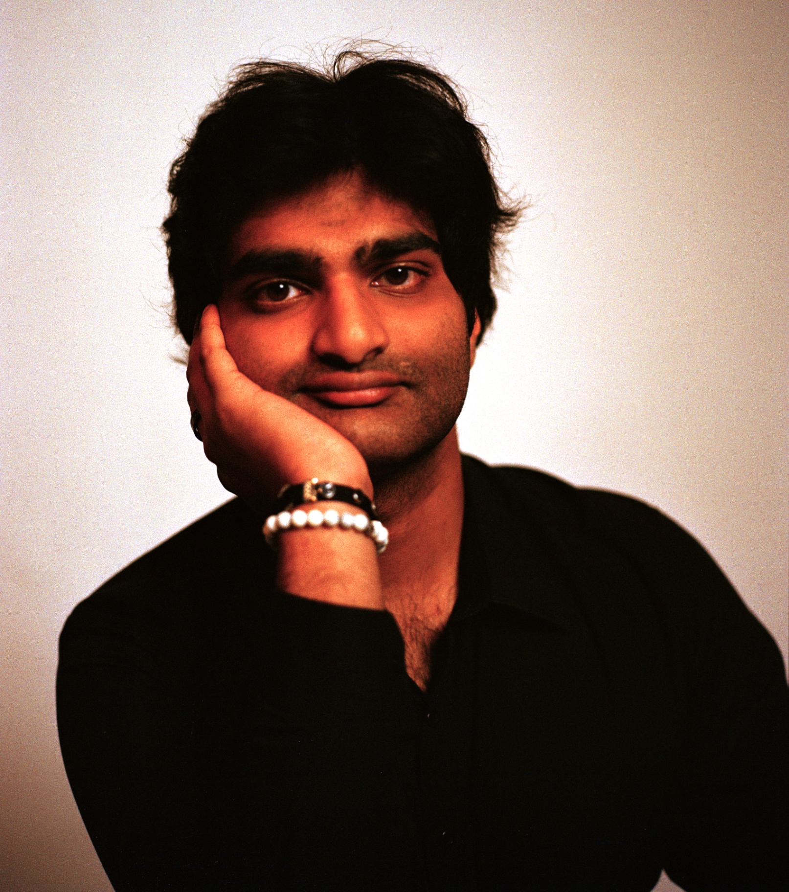 Eshan Agarwal portrait, hand on cheek in warm light